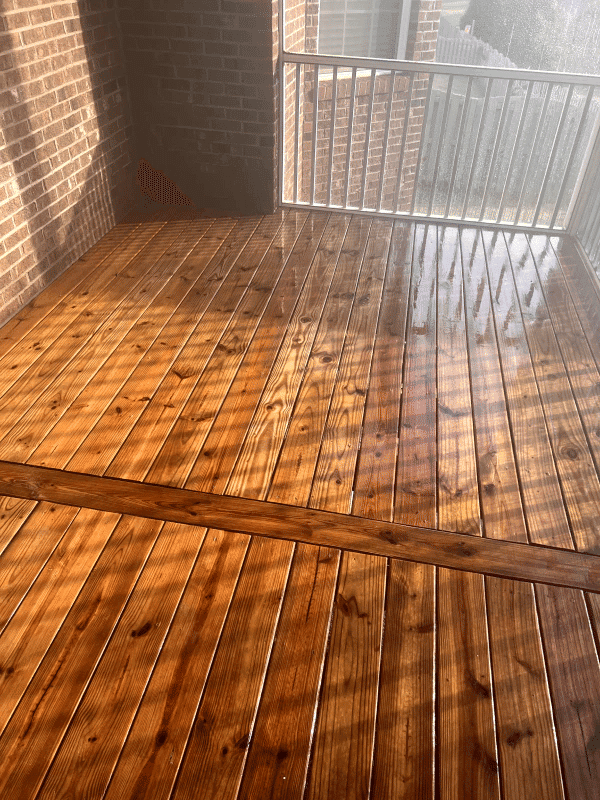 Sleek, newly finished wooden deck with glossy shine and intricate wood grain patterns.